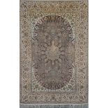 AN ISFAHAN PASTEL GROUND RUG with a central star medallion within a trailing foliate field and