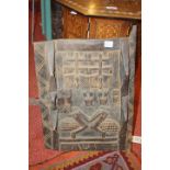 AN AFRICAN CARVED HARDWOOD DOOR with latch and stylised bird decoration, 59 x 39cm