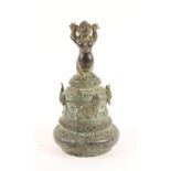 AN EARLY SOUTH EAST ASIAN BRONZE TEMPLE BELL with mythological creature finial and stylistic swag