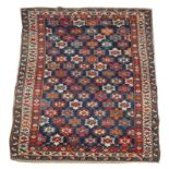 AN OLD SHIRVAN BLUE GROUND RUG with central polychrome flower head decoration within a triple