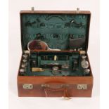 A VICTORIAN LEATHER TRAVELLING CASE fitted with various silver mounted glass bottles by varying