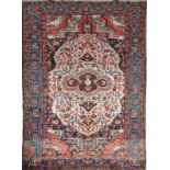 A BAKTIARI RED GROUND RUG with a central large white ground medallion and broad border, 228 x 150cm