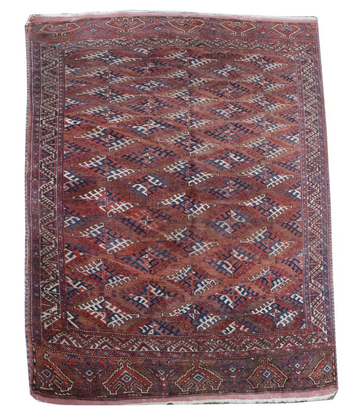 AN ANTIQUE TURKOMAN MAIN CARPET decorated with five rows of geometric latch hook medallions on a