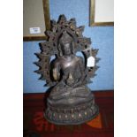 A SINO-TIBETAN KNEELING BUDDHA with right hand in abhaya mudra and left in dhyana mudra and