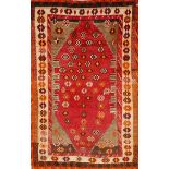 A GABBEH RED GROUND RUG with simple rosette decoration within a triple border, 168 x 105cm