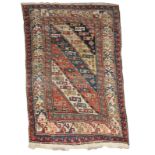 AN ANTIQUE CAUCASIAN TRIBAL RUG decorated with a polychrome diagonal and latch hook design with