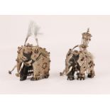 A PAIR OF INDIAN EBONY AND SILVER MOUNTED MARRIAGE ELEPHANTS inset red stones, 9cm high