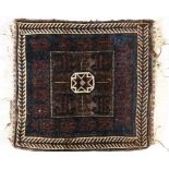 A 19TH CENTURY BELOUCH KHORJIN with silk decoration to the centre on a dark brown field, 61 x 68cm