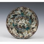 A 17TH CENTURY KUBACHI POLYCHROME POTTERY DISH decorated water fowl, other birds and foliage bearing