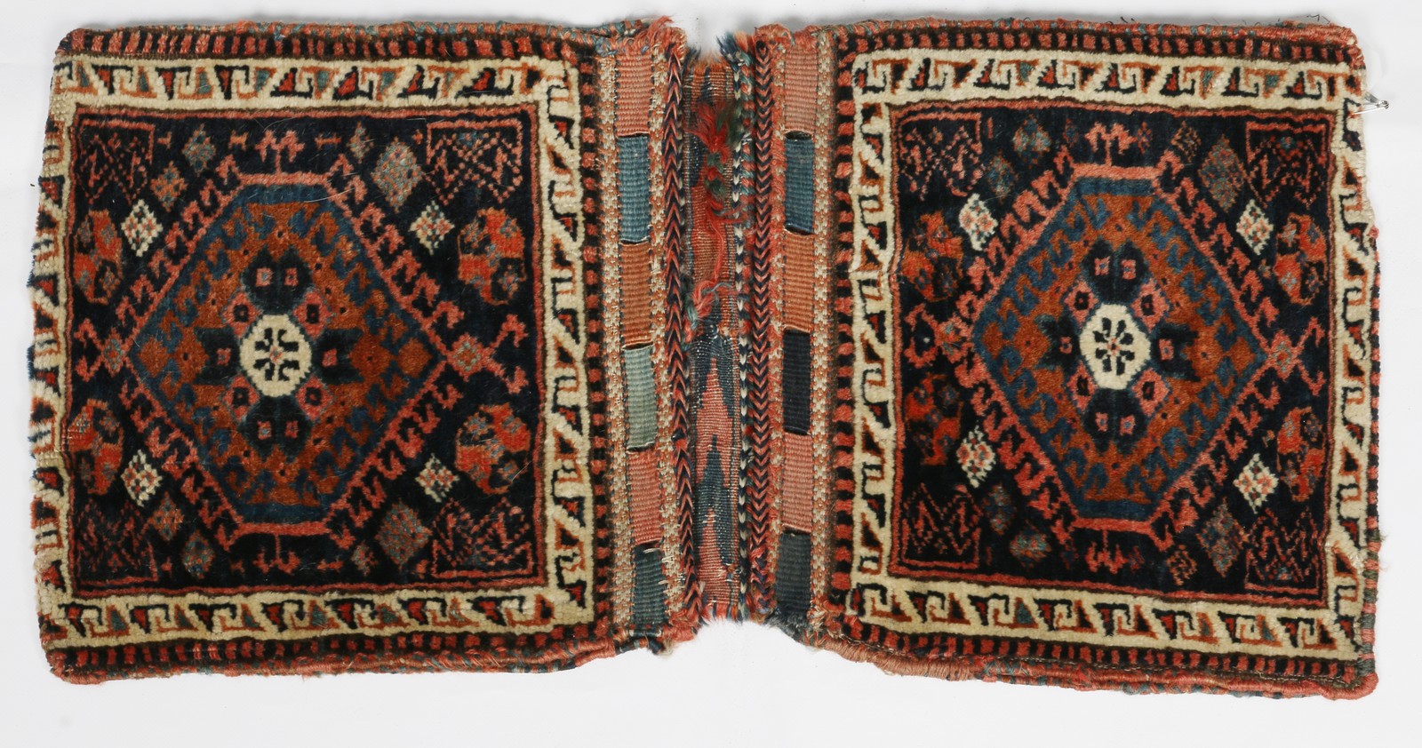 A NORTH WEST PERSIAN KHORJIN with flat weave back and geometric decoration, 64 x 33cm