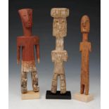 A GROUP OF THREE GHANA ADAN CARVED TRIBAL FIGURES of naive form, 20.5cm long