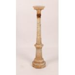 A VARIEGATED MARBLE COLUMN of classical tapering form on an octagonal base, 115cm high