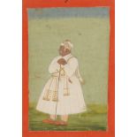 AN INDIAN MINIATURE painted with a standing figure in a landscape heightened in gilt with ink script