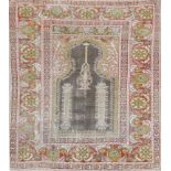 AN OLD TURKISH PANDERMA PRAYER RUG, the central lantern within a field of pastel colours, 140 x