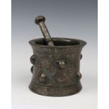 A TURKO-PERSIAN SELJUK EMPIRE BRONZE AND SILVER INLAID PESTLE AND MORTAR with stylistic scrolling