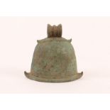 A TIBETAN BRONZE TEMPLE BELL, helmet shaped and with a ring handle, 10.5cm high