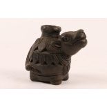 AN INDIAN BLACK SACRED COW VOTIVE POT from the Hindu Shrines at Mithila, 8cm high