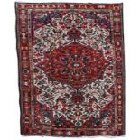 A BAKTIARI POLYCHROME RUG with central red ground medallion within a foliate field, 206 x 152cm