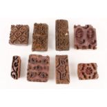 A COLLECTION OF EIGHT ANTIQUE WOODEN MOULDS OR SEALS of varying design, possibly Indian, 19th