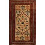 A TURKISH CAMEL GROUND RUG with stylised hook and star decoration within a multiple wine ground