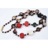 A MIDDLE EASTERN NECKLACE of interlinked agate and other beads