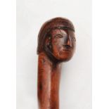 A SOUTH AMERICAN CARVED WOODEN TRIBAL STAFF with figure head handle, 101cm long