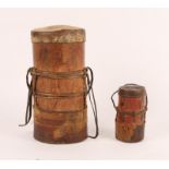 A TURKANO TRIBE CYLINDRICAL WOODEN MILK CONTAINER with leather handles and hide cover, 29cm and 15cm