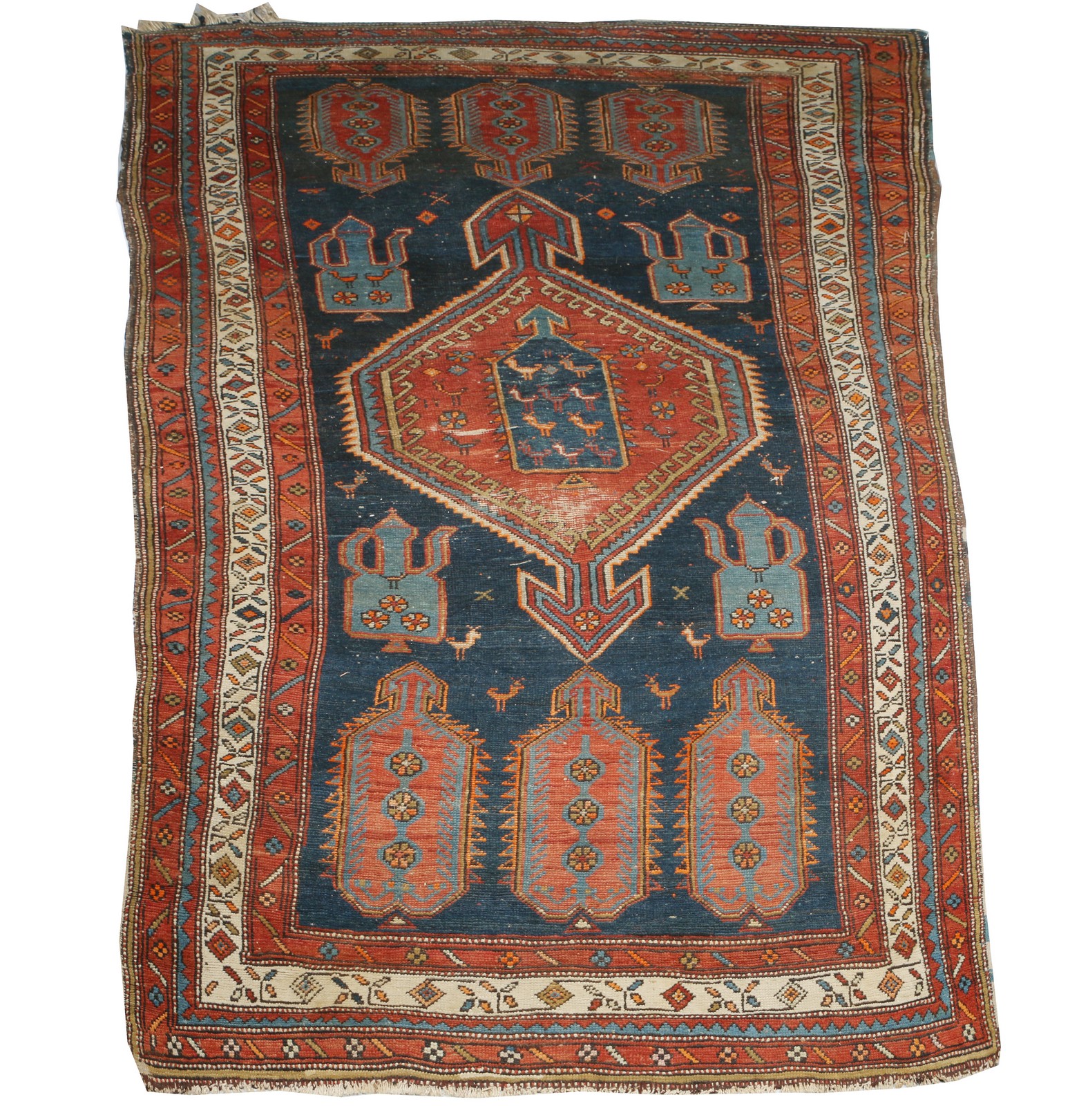 A CAUCASIAN DARK BLUE GROUND TRIBAL RUG with central medallion within a field of ewers and birds and