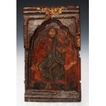 AN EARLY, POSSIBLY RUSSIAN, CARVED WOODEN ICON, perhaps a central panel from a triptych with figural