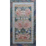 TWO CHINESE SILK SLEEVE PANELS with polychrome foliate decoration within a dark blue border, framed,