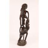 AN EAST AFRICAN SHETANI STYLE MAKONDE WOOD CARVED MYTHOLOGICAL GROUP of intertwined figures on a