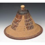 A MALIAN LEATHER AND STRAW HAT of conical form, 27cm high