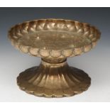 AN INDIAN BRONZE TAZZA OR ROSE PETAL DISH of pedestal form with engraved decoration, 26cm diameter