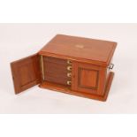 A LATE VICTORIAN POLISHED WOODEN CUTLERY BOX, the interior fitted four drawers with inset brass