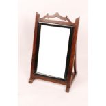 AN ANGLO INDIAN DRESSING MIRROR with bevelled glass, ebonised surround and easel frame, 91 x 53cm