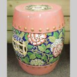 A Chinese pink pottery garden seat, 50cm
