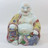 An Oriental porcelain figure of a seated