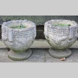 A pair of reconstituted stone planters,