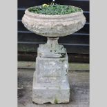 A reconstituted stone garden planter, on