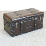 A modern brown leather travelling trunk,
