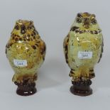 A near pair of slip decorated pottery mo