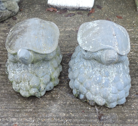 A pair of carved stone models of turtles