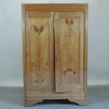 A continental walnut armoire, enclosed b