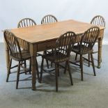A pine dining table, containing three dr