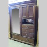 An Edwardian walnut combination wardrobe