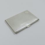 A silver cigarette case, with engine tur