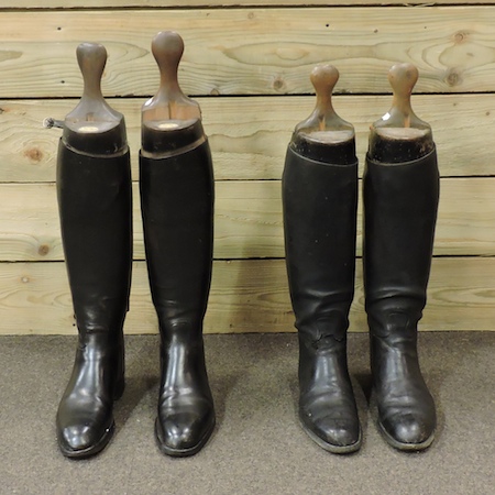 A pair of black leather riding boots, wi