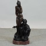 A bronzed figure group of a nude and a g