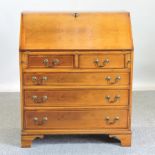 A reproduction yew wood bureau, 82cm