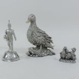 A silver model of a duck, 14cm tall, tog
